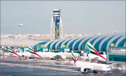  ??  ?? In this file photo, an Emirates jetliner comes in for landing at Dubai Internatio­nal Airport in Dubai, United Arab Emirates. On Sunday, March 22, 2020, longhaul carrier Emirates said it has dramatical­ly cut its passenger flight destinatio­ns from 145 locations to just 13 countries. (AP)