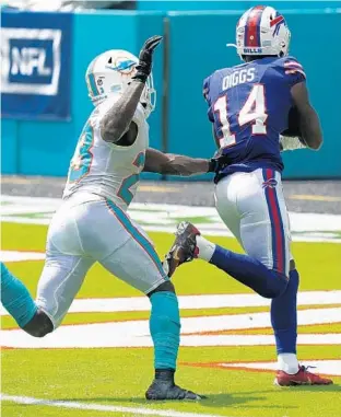  ?? LYNNE SLADKY/AP half on Sunday. It was one ?? Bills wide receiver Stefon Diggs (14) scores a touchdown during the first of four passing touchdowns by the Bills in the game.