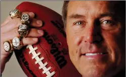  ?? JEFF SINER/TRIBUNE NEWS SERVICE ?? Dwight Clark shows off his five Super Bowl rings and the famous ball on the 25th anniversar­y of The Catch in 2007.