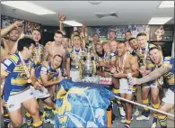  ?? PICTURE: STEVE RIDING ?? CUP GLORY: Rob Burrow, hands on flag, and his Leeds Rhinos teammates celebrate their 2014 Challenge Cup final win.