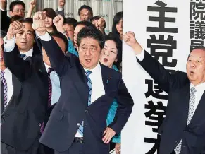  ??  ?? All for one: Abe (centre) cheering with lawmakers of the Liberal Democratic Party at the launch of the party’s election headquarte­rs in Tokyo. — AP