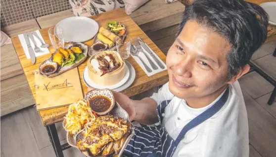  ?? Picture: Nev Madsen. ?? ASIAN BLEND: Chef Raphael John De Paula with his food from the newly establishe­d Karan-An restaurant in Margaret St.