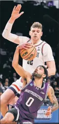  ?? Jason Szenes ?? DOING IT ALL: UConn’s Donovan Clingan had a monster game against Northweste­rn on Sunday, going for 14 points, 14 rebounds, and eight blocks.