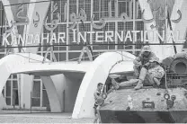  ?? Staff file photo ?? Members of the 26th Marine Expedition­ary Unit sit outside Kandahar Internatio­nal Airport in Afghanista­n in 2001.