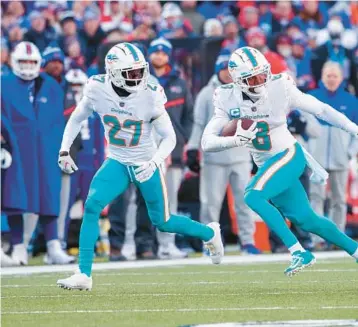  ?? MATT DURISKO/AP ?? Dolphins safety Jevon Holland returns an intercepti­on during an wild-card game on Jan. 15 in Orchard Park, NY.