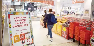  ?? — AFP photo ?? A sign, seen in a Coles supermarke­t, advises its customers of its plastic bag free policy in Sydney.