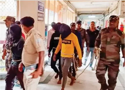  ?? AFP PHOTO ?? ALLEGED ATTACKERS
Police officers escort men accused of gang-raping a Spanish tourist to a court in Dumka district, Jharkhand state, eastern India on Monday, March 4, 2024.