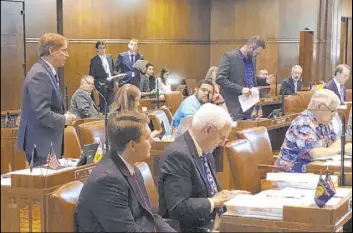  ?? Andrew Selsky The Associated Press ?? Sen. Tim Knopp, R-Bend, left, addresses the Oregon Senate in Salem, Ore., on Saturday after Republican senators ended their walkout over an emissions bill.