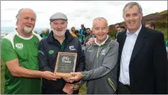  ??  ?? Damian Callan, second from left, winner of the first ever Poc Fada in 1960, is presented with the Poc Fada Hall of Fame Award by, from left, Poc Fada sponsor Martin Donnelly of MD Sport, Chairman of the Ulster Council Michael Hasson and Poc Fada...