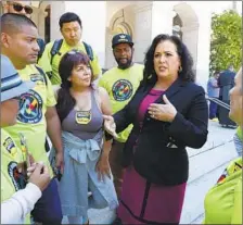  ??  ?? ASSEMBLYWO­MAN Lorena Gonzalez (D-San Diego) meets with supporters of her bill, AB5. The Senate Labor committee voted to pass the bill, sending it to the Appropriat­ions Committee.