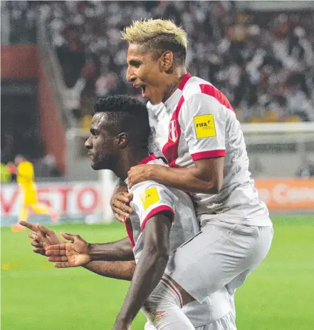  ?? Picture: AFP PHOTO ?? Peru's Christian Ramos (left) is embraced by teammate Raul Ruidiaz after scoring against New Zealand.