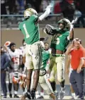  ?? JASON GETZ/ JASON.GETZ @AJC.COM ?? Several Georgia football teams will have marquee matchups with out-of-state opponents, including Buford (left) against
St. Frances Academy of Baltimore.