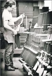  ??  ?? A Marlin employee inspects a gun in a shipping room in October 1990.