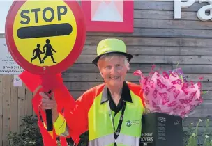  ??  ?? Pam Pearson was awarded the BEM in the Queen’s birthday honours was presented with flowers at Parkroyal School in Macclesfie­ld