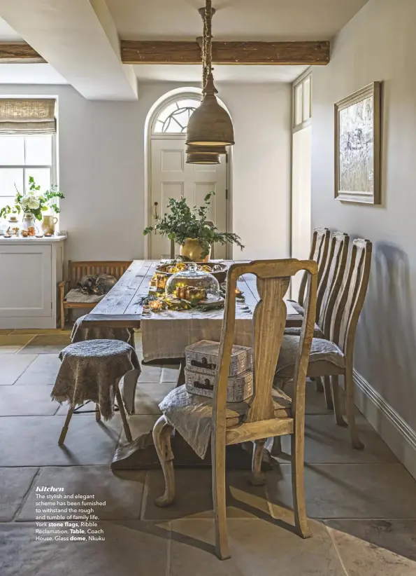  ??  ?? Kitchen
The stylish and elegant scheme has been furnished to withstand the rough and tumble of family life. York stone flags, Ribble Reclamatio­n. Table, Coach House. Glass dome, Nkuku