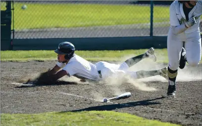  ?? PHOTOS BY JOEL ROSENBAUM — THE REPORTER ?? St. Patrick-St. Vincent High’s Joseph Guttmann slides home safely Monday as teammate Mason Reynolds sprints toward first base after successful­ly laying down a suicide squeeze in the sixth inning of the Bruins’ 7-5 victory over American Canyon.