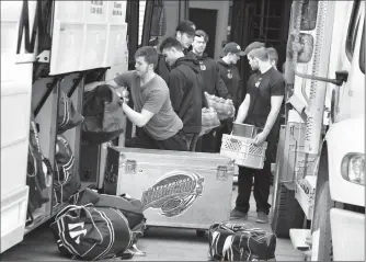  ?? Herald photo by Ian Martens ?? The Lethbridge Hurricanes’ load up the bus before hitting the road Thursday for the trip to Regina to face the Pats in the WHL Eastern Conference finals.