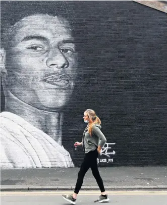  ??  ?? On the wall: A mural of Marcus Rashford in Manchester