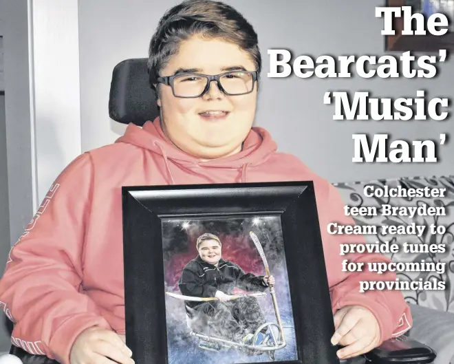  ?? RICHARD MACKENZIE ?? Brayden Cream holds up the photo given to him as a Christmas gift by former Truro Major U-15 captain Brayden Schmitt, a Bible Hill native who currently plays defence for the Blainville Boisbriand Armada of the Quebec Major Junior Hockey League.