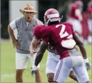  ?? VASHA HUNT — AL.COM VIA AP ?? Alabama coach Nick Saban works with his players during NCAA college football practice Aug. 16 in Tuscaloosa, Ala.