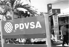  ??  ?? The logo of the Venezuelan state oil company PDVSA is seen at a gas station in Caracas. Venezuela has given up the fight for coveted market share in India because of a combinatio­n of declining crude production and heavy obligation­s under oil-for-loan...