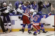 ?? Adam Hunger / Associated Press ?? Lightning and Rangers players fight at the end of Game 5 of the Eastern Conference finals on Thursday.