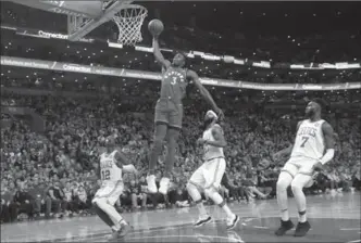  ?? WINSLOW TOWNSON, THE ASSOCIATED PRESS ?? Toronto Raptors forward OG Anunoby goes in for a dunk past Celtics’ Terry Rozier, left, Marcus Morris and Jaylen Brown in the second quarter in Boston on Sunday. The Celtics won the game, 95-94.