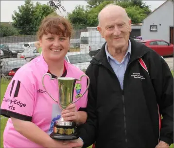  ??  ?? Leanne Delaney, the Adamstown captain, receives the cup from Tom ‘Flash’ Dunne.