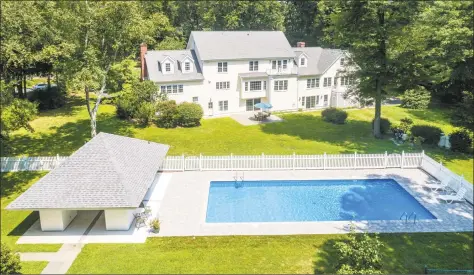  ?? Photos by Halstead Connecticu­t ?? Above: The heated pool, cabana, fencing, decking and Har Tru clay tennis court at 10 Snowberry Lane in New Canaan were all renovated in 2017. Below: The five-bedroom colonial features a formal living room with a fireplace. The four-level home is listed for $1.799 million.