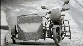  ?? AARON FAVILA — THE ASSOCIATED PRESS ?? A motorcycle that is covered in volcanic ash is left by it’s owner at a deserted village near Taal volcano in Talisay, Batangas province, southern Philippine­s on Friday. Taal volcano remains life-threatenin­g despite weaker emissions and fewer tremors, an official said Friday and advised thousands of displaced villagers not to return to the danger zone.