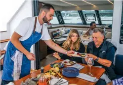  ??  ?? LEFT Chef Andrea Catalinni serves guests with dessert.
BELOW A yoke is used to stop the catamaran crabbing around the anchorage.