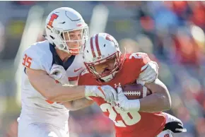  ?? ASSOCIATED PRESS ?? UW tailback Taiwan Deal had 111 yards rushing and two touchdowns on just 12 carries Saturday against Illinois.