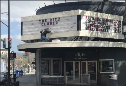  ?? PHOTO BY SAL PIZARRO ?? A worker posts a “closed” sign for the Ritz nightclub in downtown San Jose on Friday, in accordance with Santa Clara County health orders issued because of the coronaviru­s. Shows are being canceled, galleries are closing, and fundraisin­g galas are being scrapped.