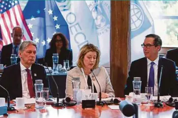  ?? REUTERS PIC ?? British Secretary of State for Internatio­nal Developmen­t Penny Mordaunt (centre) speaking as United States Treasury Secretary Steven Mnuchin (right) and British Chancellor of the Exchequer Philip Hammond look on at the G7 Finance Ministers Summit in...