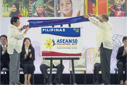  ?? EPA ?? Filipino President Rodrigo Duterte, left, unveils a commemorat­ive stamp marking the Philippine­s’ 2017 Asean Chairmansh­ip in Davao city, Philippine­s. As a member with the least awareness about the regional grouping, the Philippine­s has a reputation for...