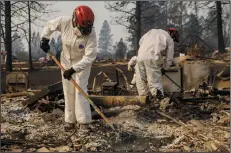  ?? MARCUS YAM/LOS ANGELES TIMES ?? A search and rescue team combs through the debris for possible human remains at Paradise Gardens, in Paradise on Friday.