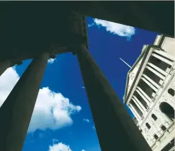  ?? (Neil Hall/Reuters) ?? THE BANK of England is seen through the columns on the Royal Exchange building in London. The biggest interventi­on in Britain’s banking market in four years is likely to offer a modest boost to growth, but is not seen as a ‘gamechange­r.’