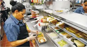  ?? ASSOCIATED PRESS FILE PHOTO ?? Silvia Ruiz prepares a specialty sandwich at a McDonald’s restaurant in Chicago. The company that helped define fast food is making supersized efforts to reverse its fading popularity and catch up to a landscape that has evolved around it.
