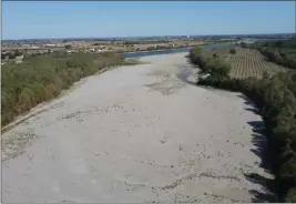  ?? LUIGI NAVARRA — THE ASSOCIATED PRESS ?? The dry riverbed of the Po River in Sermide, Italy, is seen Thursday. The Po runs 405 miles from the northwest city of Turin to Venice. But northern Italy hasn't seen rainfall for months and this year's snowfall was down by 70%. Higher temperatur­es did the rest.