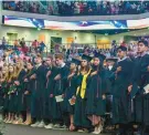  ?? KAREN JACKSON/BALTIMORE SUN MEDIA ?? Seniors and guests stand for the Pledge of Allegiance during the 61st annual Dulaney High School commenceme­nt.