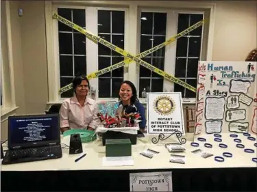  ?? SUBMITTED PHOTOS ?? Zoe Wallace and Abby Richter man an informatio­n booth at Sunnybrook during the Pottstown/Pottsgrove Border Battle Wrestling Match