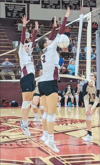  ?? Westside Eagle Observer/RANDY MOLL ?? Gentry juniors Abigail Schopper (No. 15) and Reese Hester (No. 2) go up to block a shot during play against West Fork in Gentry on Aug. 29.