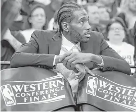  ?? Edward A. Ornelas / San Antonio Express-News ?? The Spurs’ Kawhi Leonard fidgets on the bench as his team loses to the Warriors in Game 3 of the Western Conference finals. Leonard has an ankle injury.