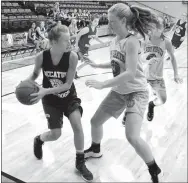  ?? Photo by Mike Eckels ?? Decatur’s Paige Vann (left) moved along the baseline in an attempt to find an open Decatur player during the team camp at the Lincoln High School gym in Lincoln July 21. The Greenland Lady Pirates won the contest, 18-4, over the Lady Bulldogs.