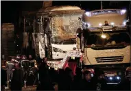  ?? AP/NARIMAN EL-MOFTY ?? Egyptian officers stand alongside a tour bus that was targeted by a roadside bomb Friday near the Giza Pyramids in Cairo.