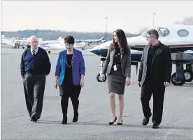  ?? LANCE ANDERSON METROLAND ?? Ken MacLennan, 85, the first manager of the Peterborou­gh Municipal Airport, Nancy Hewitt, airport administra­tor, Lisa Davidson, airport manager, and Trent Gervais, airport general manager, discuss plans for next year’s 50th Anniversar­y Airshow featuring the Snowbirds while walking on the tarmac Wednesday.