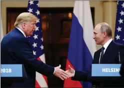  ?? AP Photo/Alexander Zemlianich­enko ?? Shaking hands: U.S. President Donald Trump shakes hand with Russian President Vladimir Putin at the end of the press conference after their meeting at the Presidenti­al Palace in Helsinki, Finland, Monday.