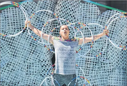  ?? JIM DAY/THE GUARDIAN ?? Christophe­r Mejaki, a performer in The Dream Catchers, dazzles the crowd with an artistic and athletic hoop dance.