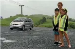  ?? JENNY LING / FAIRFAX NZ ?? Principal Christine Gilmore provides pupils Bayleigh and Te Ahi Makene with high-vis vests.