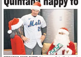  ?? N.Y. Post: Charles Wenzelberg ?? SPREADING GOOD CHEER: Mets manager Carlos Mendoza and pitcher Carlos Quintana (Santa) hand out presents Wednesday during the Mets’ annual Kids Holiday Party at Citi Field.